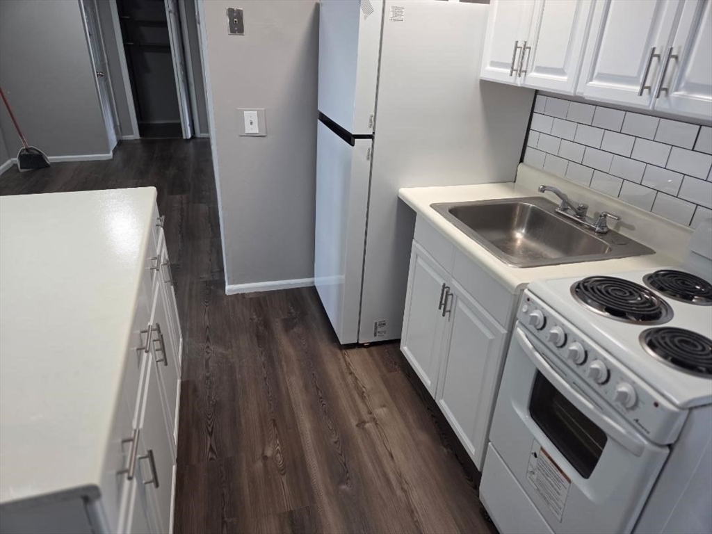 14 Carver Street, Unit 3 Fall River, MA 02721 - Photo 3 of 8 a kitchen with a sink a stove and refrigerator