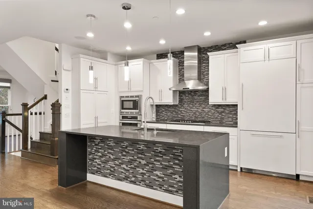 a kitchen with granite countertop cabinets and wooden floor
