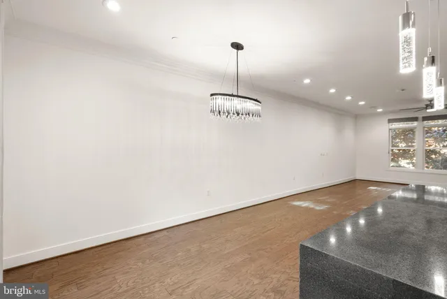 a view of wooden floor and a window in a room