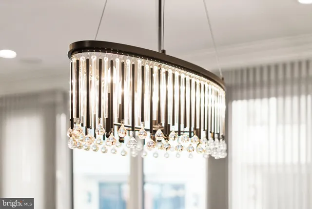 wooden floor in an empty room with a window and a kitchen