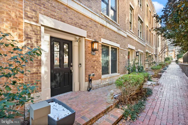 a view of a brick building next to a yard