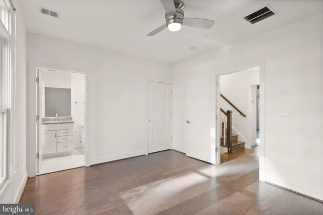 a kitchen with a stove and white cabinets