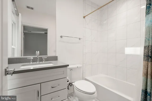 wooden floor in an empty room with a kitchen