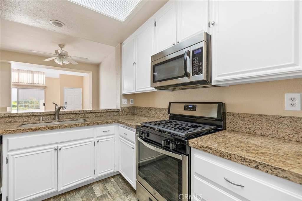 29489 Cara Way Temecula, CA 92591 - Photo 1 of 1 a kitchen with granite countertop white cabinets stainless steel appliances and a sink