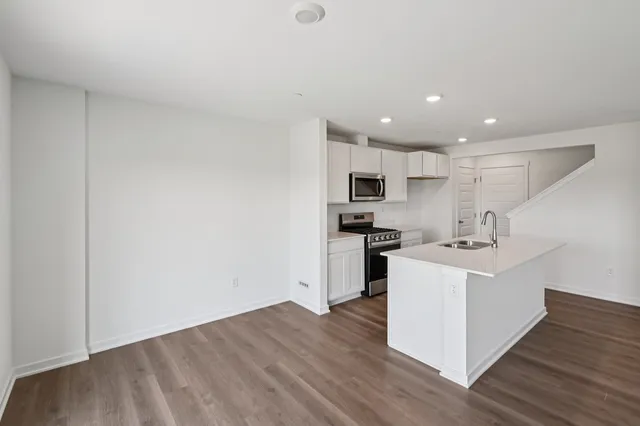 a view of kitchen with sink and microwave