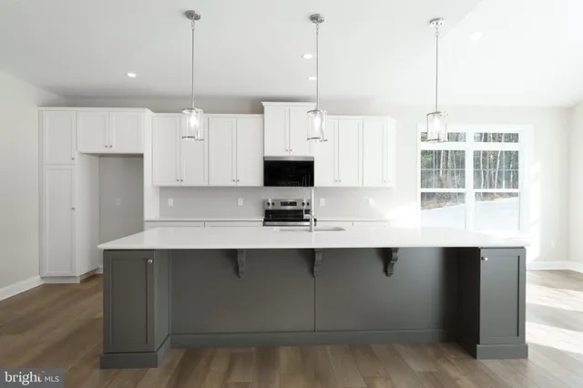 a open kitchen with granite countertop a stove and a sink