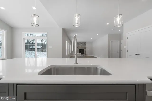 a view of empty room with wooden floor and windows