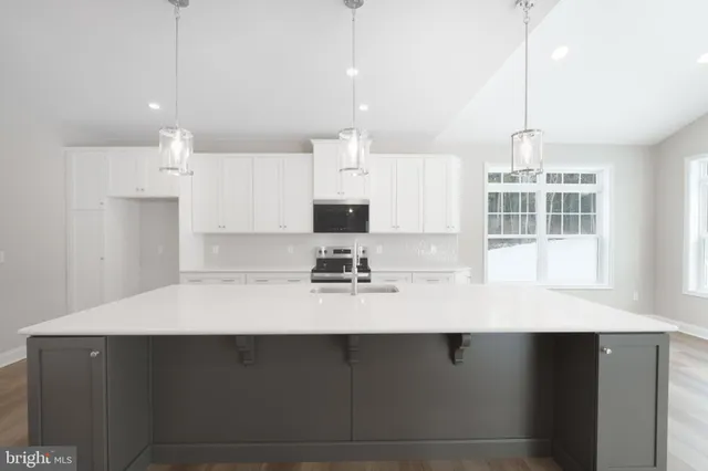 an empty room with wooden floor and fireplace