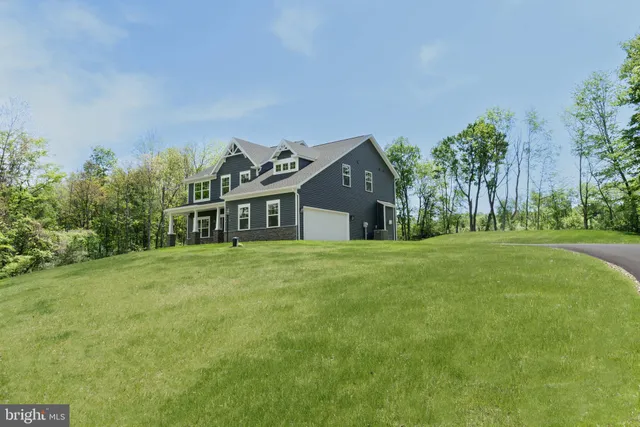 a front view of a house with outdoor seating