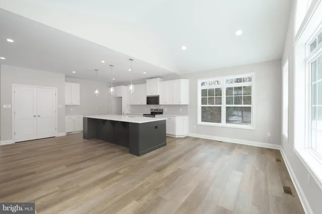 a view of bathroom with a sink mirror and shower