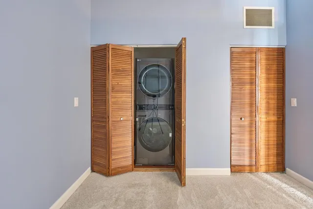 an empty room with a fireplace and windows