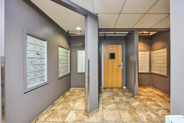 a view of balcony with a large window and potted plant on the side of a house