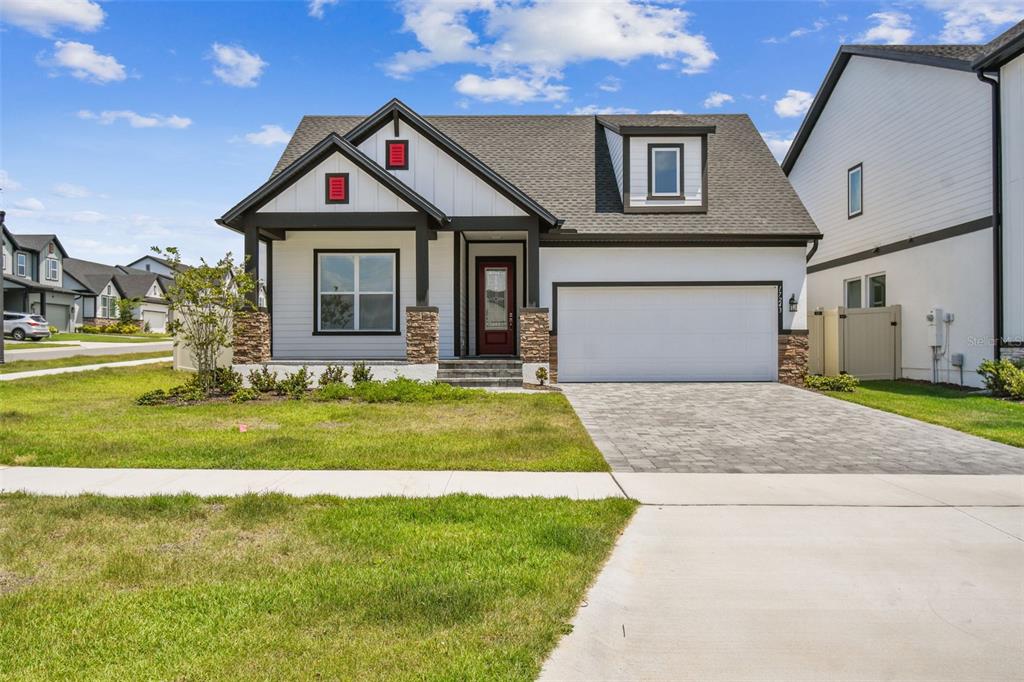 17243 Cercis Loop Clermont, FL 34711 - Photo 1 of 1 a front view of a house with a yard and garage