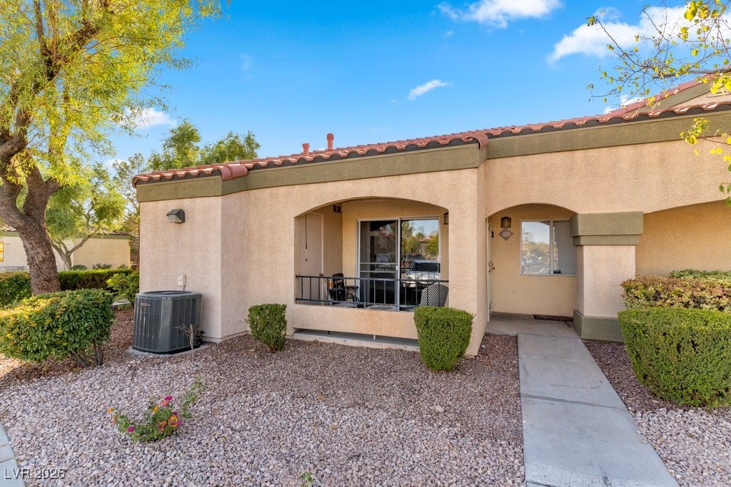 Property entrance with a tile roof and stucco siding