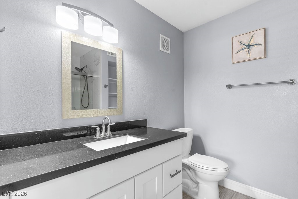 7885 West Flamingo Road, Unit 1053 Las Vegas, NV 89147 - Photo 14 of 33 Full bath featuring a shower, vanity, and a textured wall