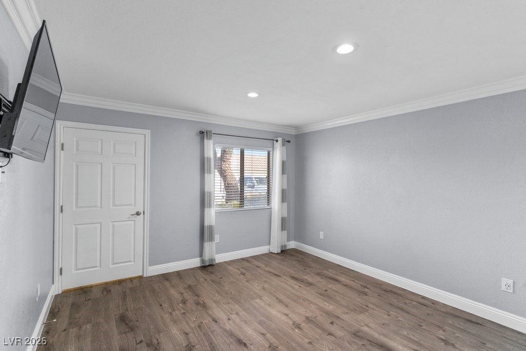7885 West Flamingo Road, Unit 1053 Las Vegas, NV 89147 - Photo 15 of 33 Unfurnished bedroom with ornamental molding, wood finished floors, and recessed lighting