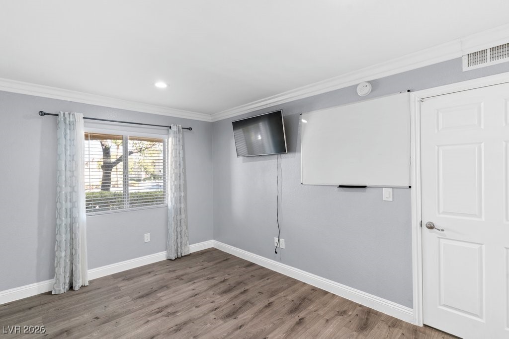 7885 West Flamingo Road, Unit 1053 Las Vegas, NV 89147 - Photo 19 of 33 Unfurnished room with ornamental molding, wood finished floors, and recessed lighting