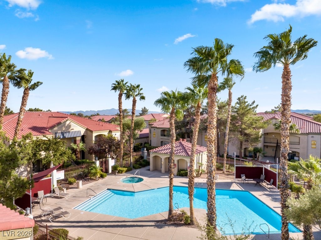 7885 West Flamingo Road, Unit 1053 Las Vegas, NV 89147 - Photo 26 of 33 Community pool with a patio, a hot tub, and a residential view
