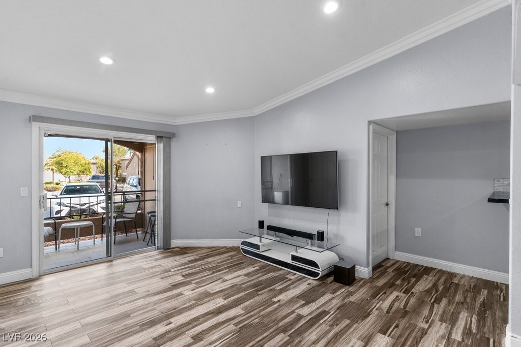 7885 West Flamingo Road, Unit 1053 Las Vegas, NV 89147 - Photo 9 of 33 Unfurnished living room featuring crown molding, light wood-style floors, and recessed lighting