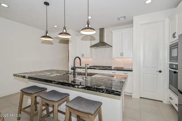 a spacious bedroom with a bed and a potted plant