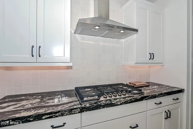 a spacious bedroom with a bed and a couch