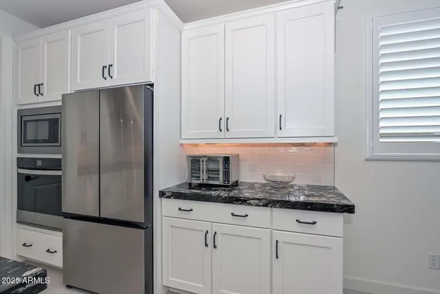 a bathroom with a double vanity sink mirror and bathtub