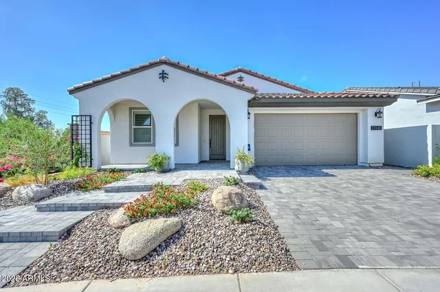 a kitchen with stainless steel appliances granite countertop a sink a stove a refrigerator and chairs