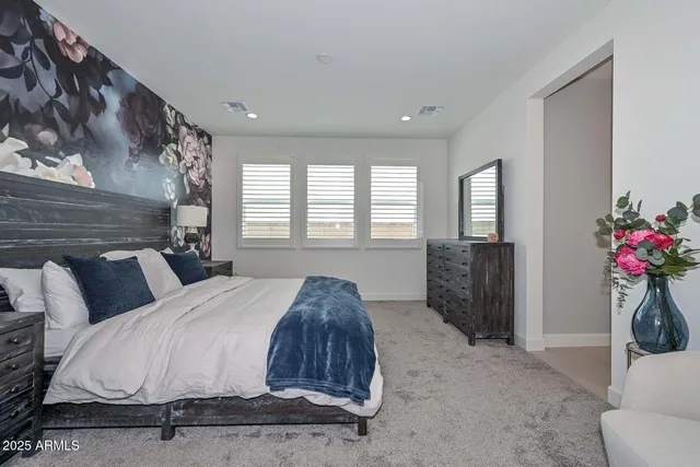 a green field with white fence