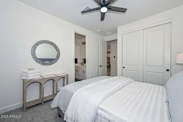 a living room with lots of furniture and view of kitchen