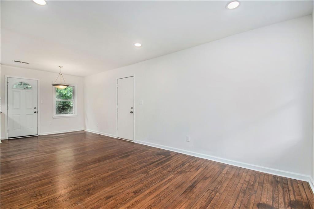 980 Fairburn Road Northwest Atlanta, GA 30331 - Photo 3 of 8 a view of an empty room with wooden floor and a window
