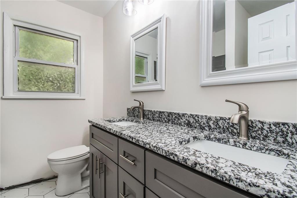 980 Fairburn Road Northwest Atlanta, GA 30331 - Photo 7 of 8 a bathroom with a granite countertop toilet sink and mirror