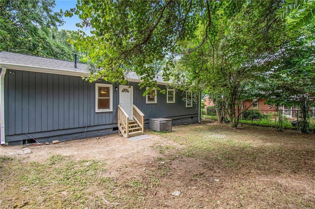 980 Fairburn Road Northwest Atlanta, GA 30331 - Photo 8 of 8 a view of a house with a tree and wooden fence