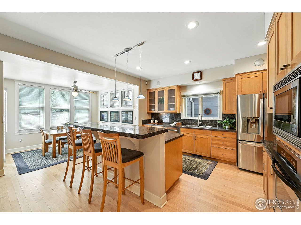 3561 4th Street Boulder, CO 80304 - Photo 17 of 50 a kitchen with stainless steel appliances kitchen island granite countertop a table and chairs