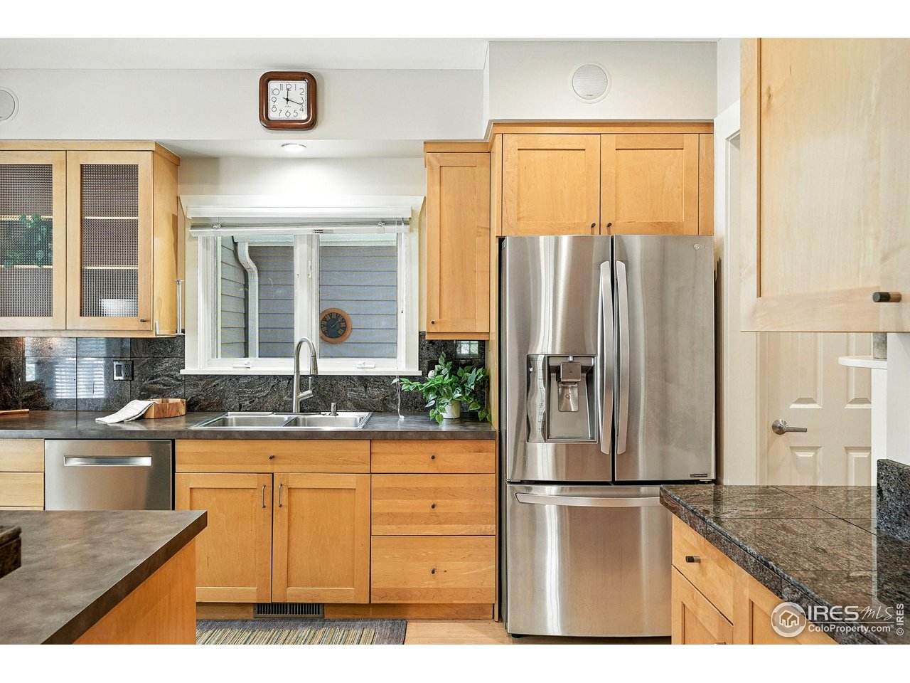 3561 4th Street Boulder, CO 80304 - Photo 19 of 50 a kitchen with granite countertop a refrigerator and a sink