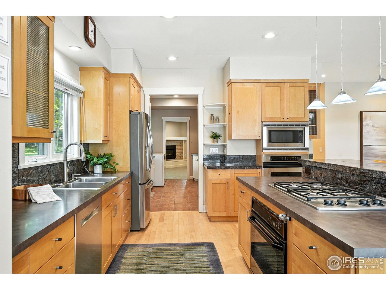 3561 4th Street Boulder, CO 80304 - Photo 21 of 50 a kitchen with stainless steel appliances kitchen island granite countertop a stove refrigerator and cabinets
