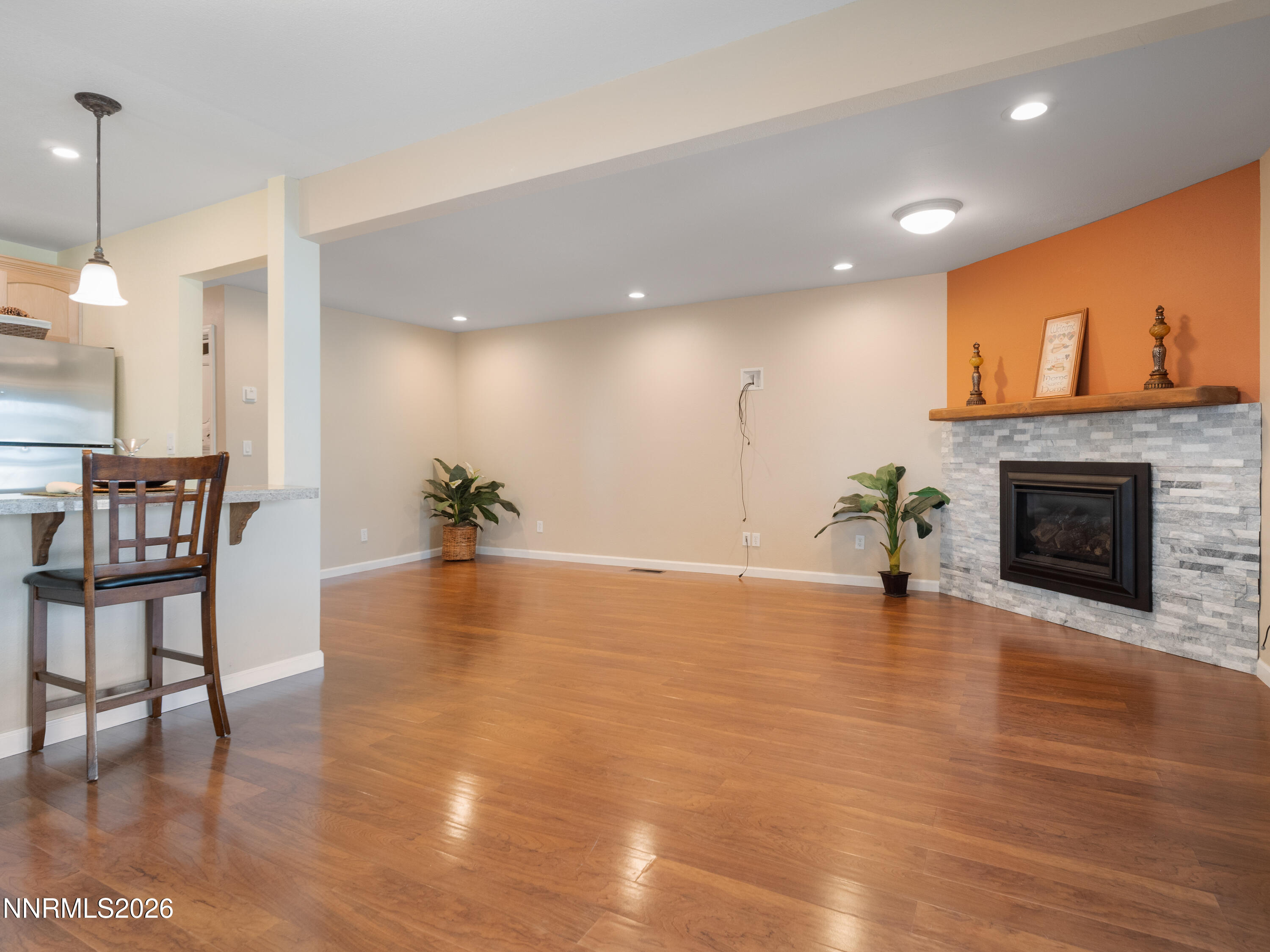 761 Milky Way Court, Unit A Stateline, NV 89449 - Photo 12 of 43 an empty room with wooden floor and a fireplace
