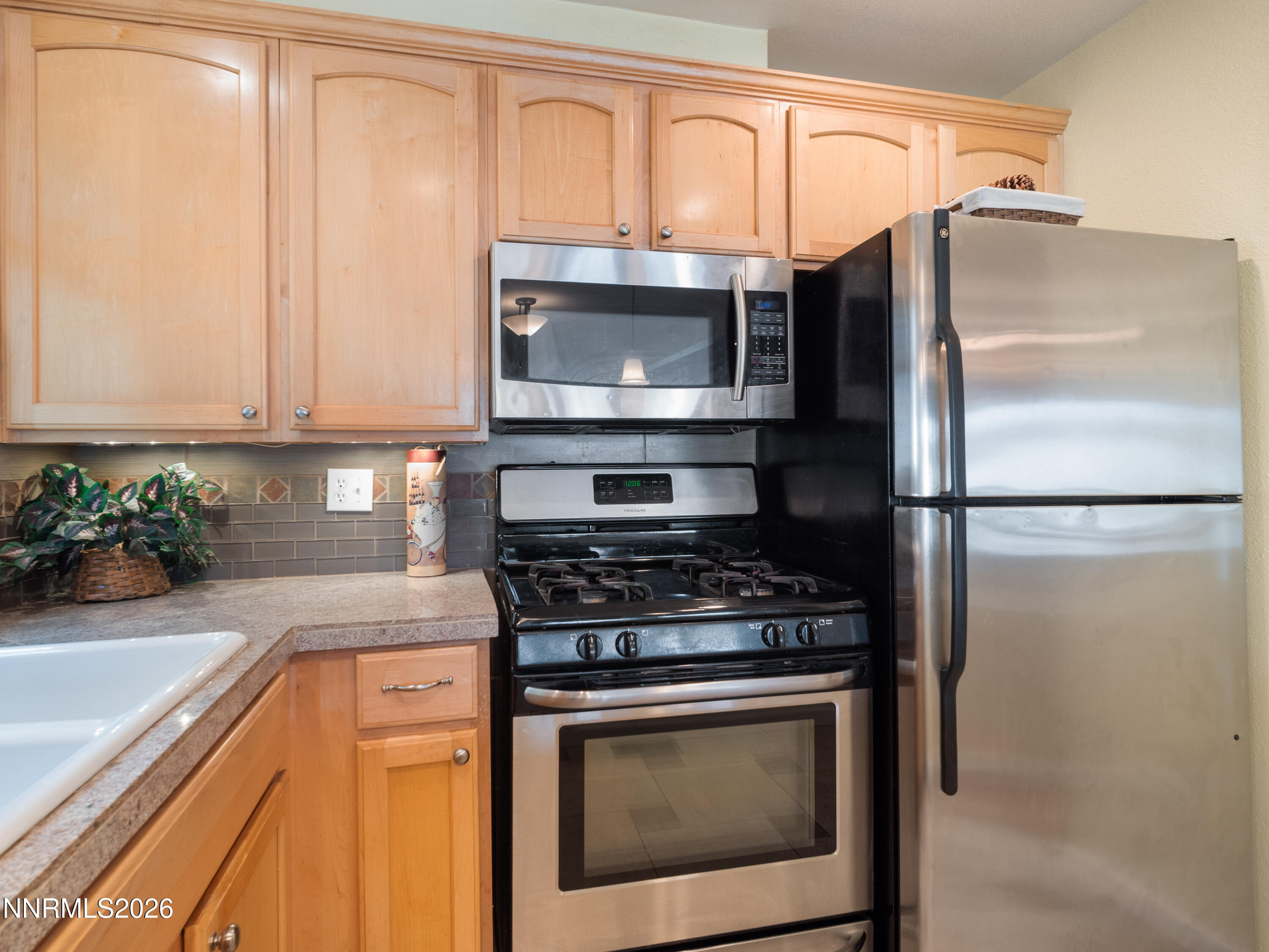 761 Milky Way Court, Unit A Stateline, NV 89449 - Photo 14 of 43 a kitchen with stainless steel appliances granite countertop a stove a refrigerator and a sink