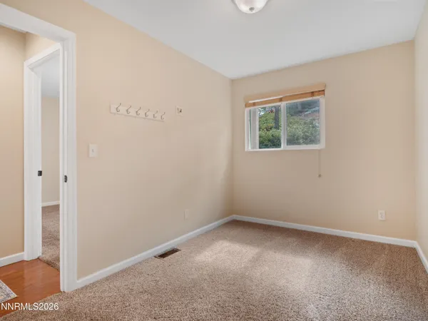 an empty room with potted plants
