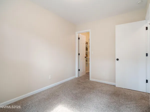a bathroom with a refrigerator and a cabinets