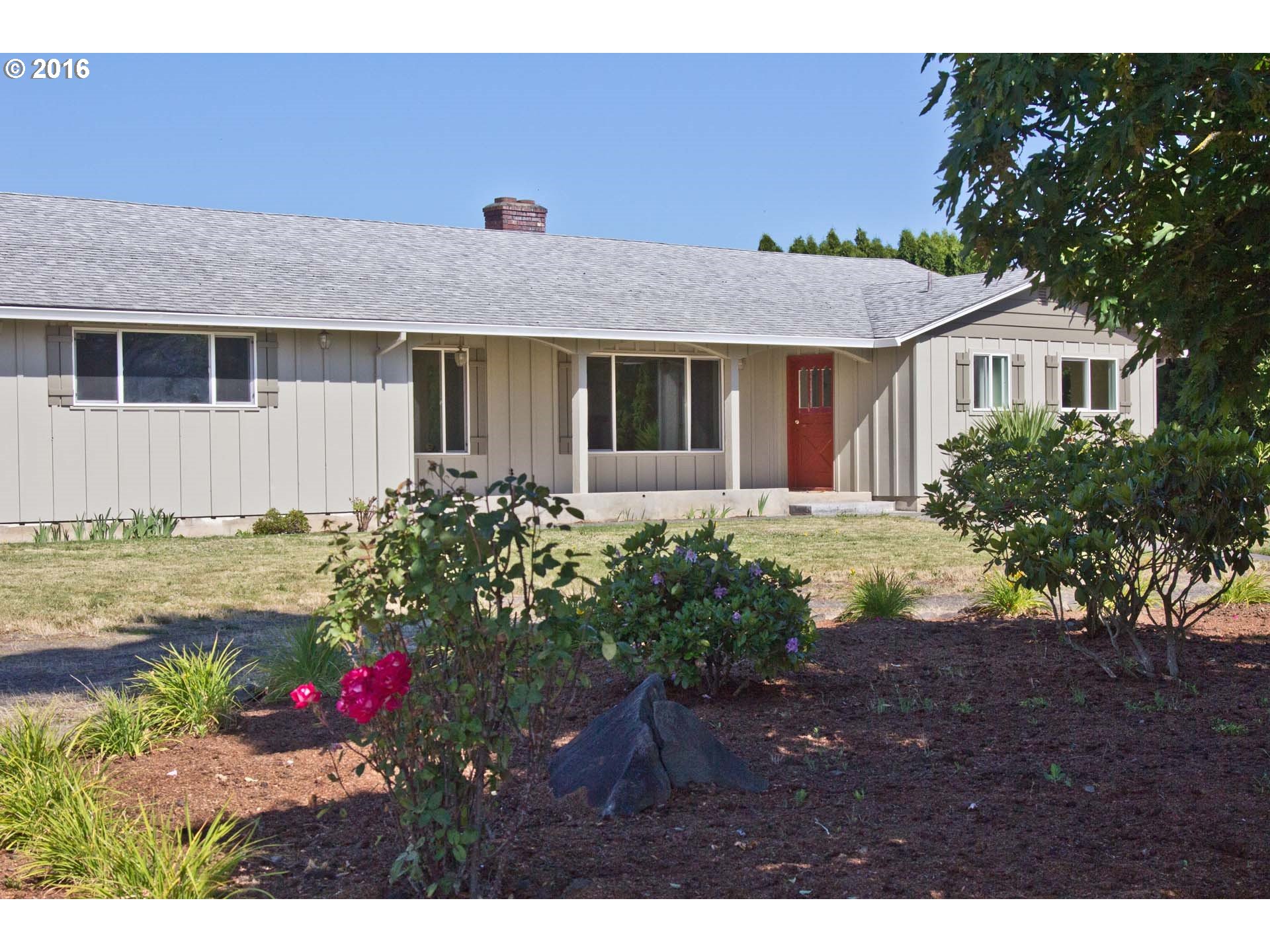 8473 South Heinz Road Canby, OR 97013 - Photo 1 of 32 a front view of a house with a garden