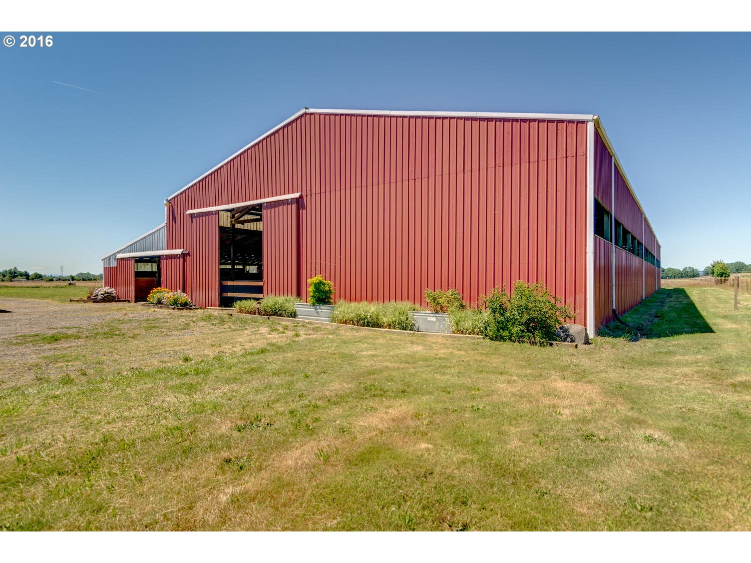 8473 South Heinz Road Canby, OR 97013 - Photo 14 of 32 a view of an house with backyard and bushes