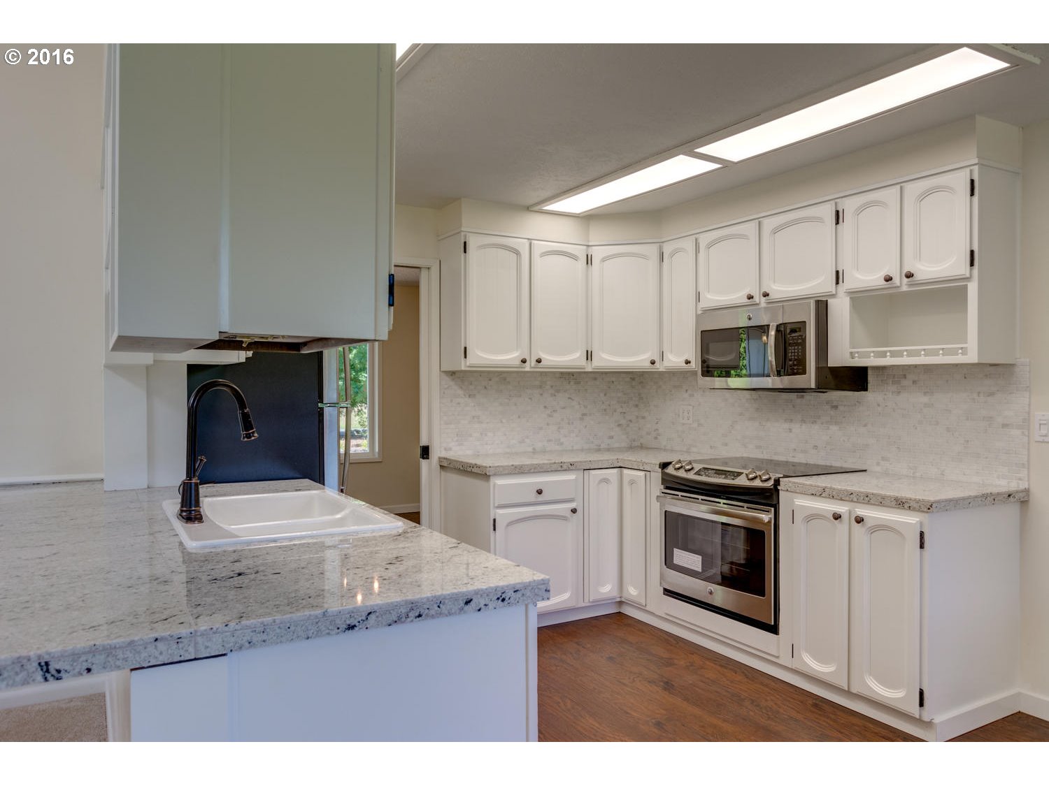 8473 South Heinz Road Canby, OR 97013 - Photo 2 of 32 a kitchen with stainless steel appliances granite countertop a stove a sink and a microwave