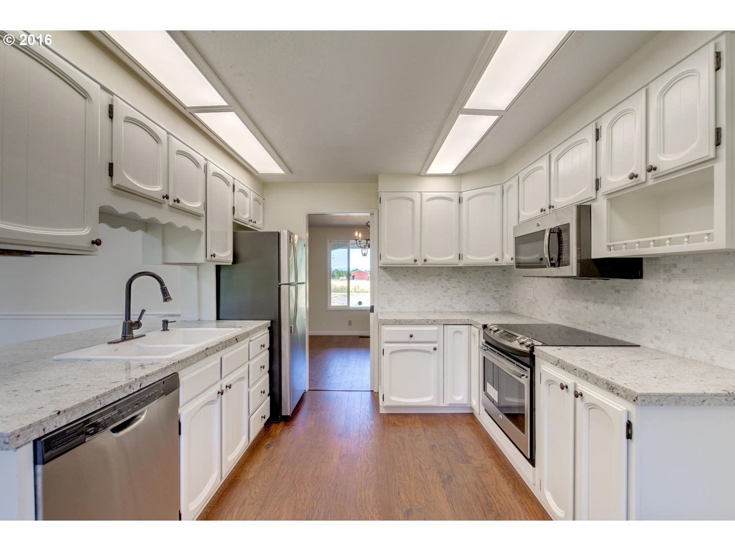 8473 South Heinz Road Canby, OR 97013 - Photo 3 of 32 a kitchen with stainless steel appliances granite countertop a sink a stove and cabinets