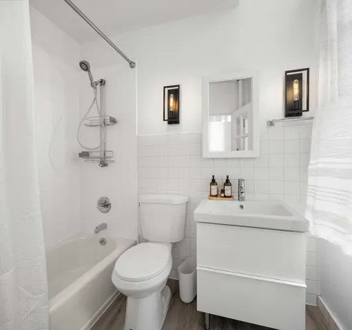 a bathroom with a sink toilet and shower