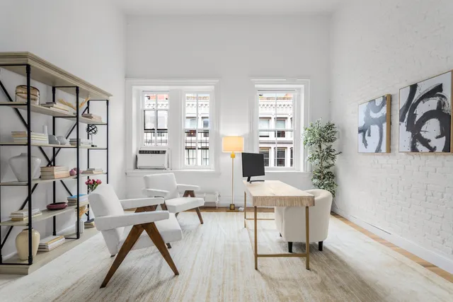 a workspace with furniture and a wooden floor