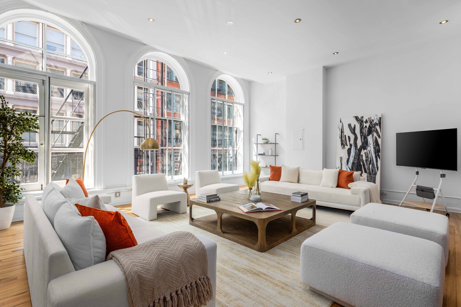 508 Broadway Manhattan, NY 10012 - Photo 3 of 38 a living room with furniture and a flat screen tv