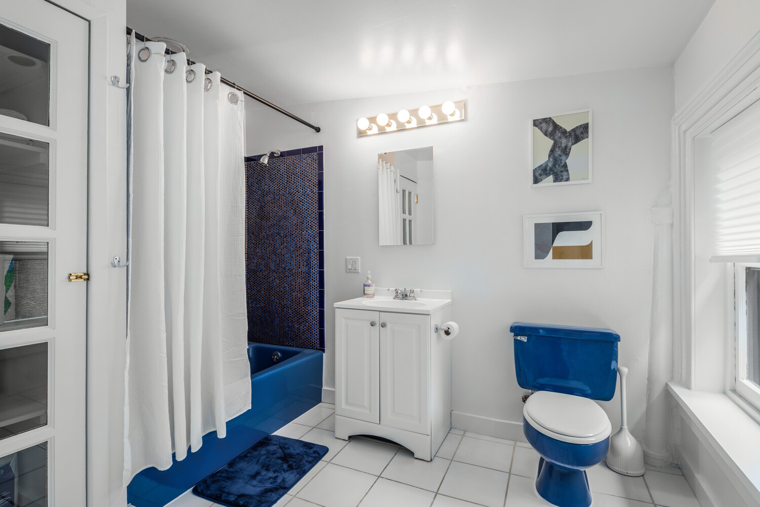 508 Broadway Manhattan, NY 10012 - Photo 36 of 38 a bathroom with a toilet a sink and mirror