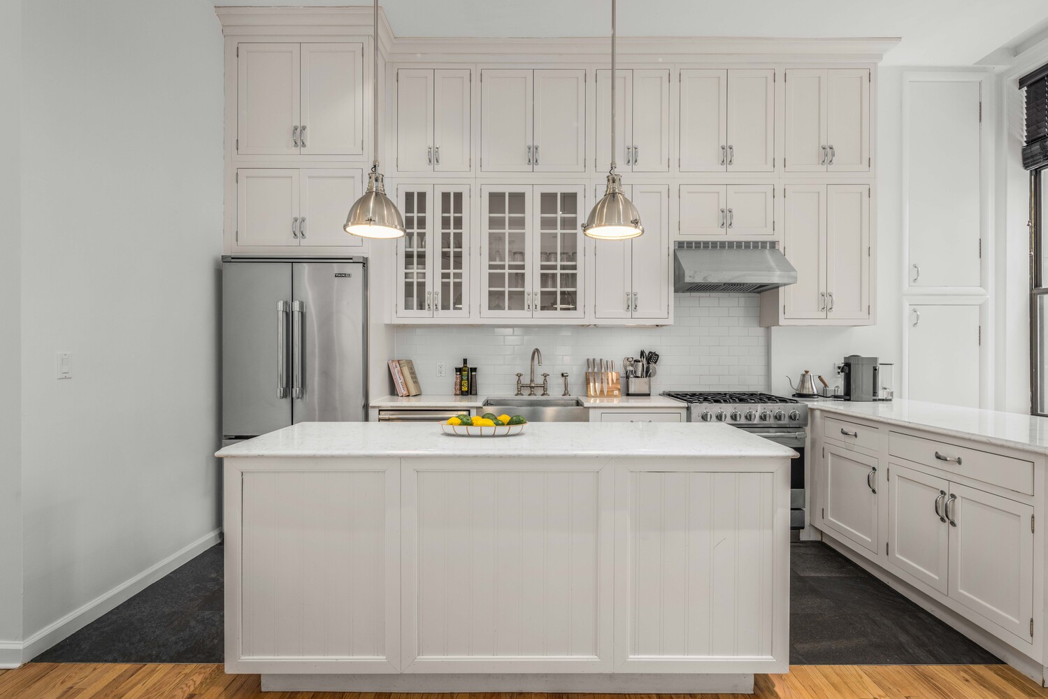 508 Broadway Manhattan, NY 10012 - Photo 9 of 38 a kitchen with stainless steel appliances granite countertop a sink a stove and white cabinets
