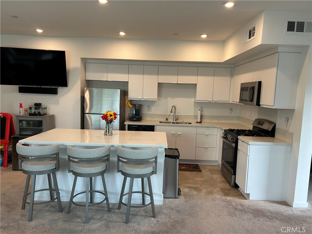 400 West Central Avenue, Unit 304 Brea, CA 92821 - Photo 2 of 17 a kitchen with stainless steel appliances granite countertop a stove a sink a microwave a refrigerator and cabinets