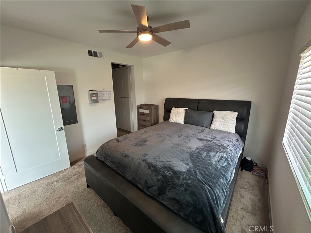 400 West Central Avenue, Unit 304 Brea, CA 92821 - Photo 6 of 17 a bedroom with a bed and a large window